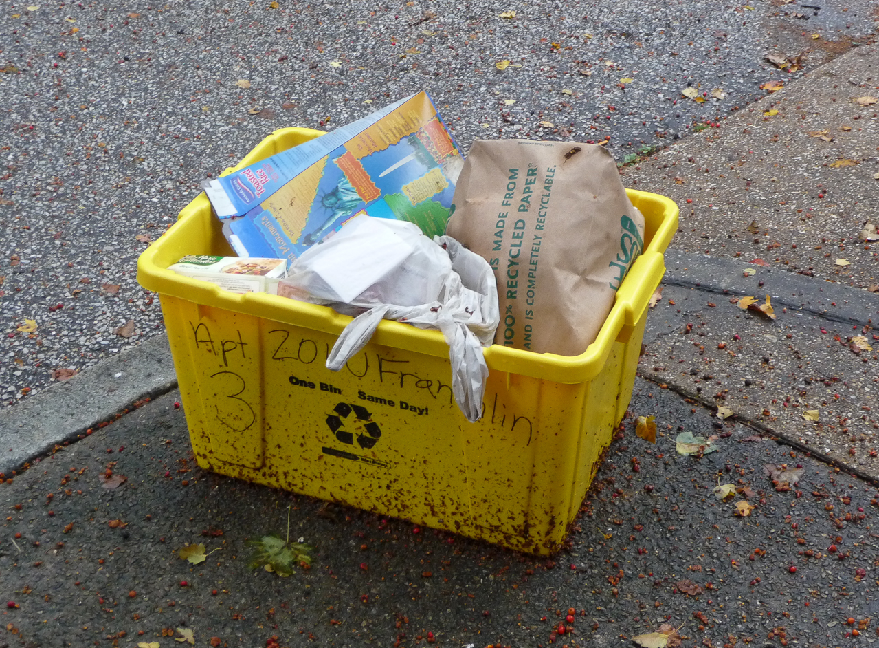Recycling bins on the sidewalk