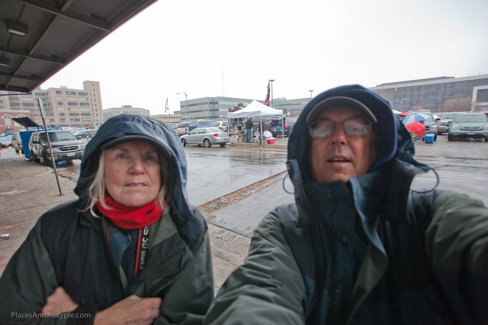 A wet but happy Peg and Bernie do their POD (Picture of the Day) with the hardy Ram tailgaters in the background