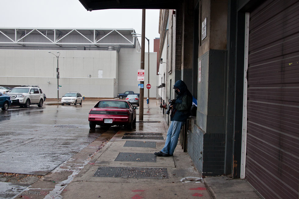 Bernie takes shelter in a loading dock across the street and wipes off the gear!